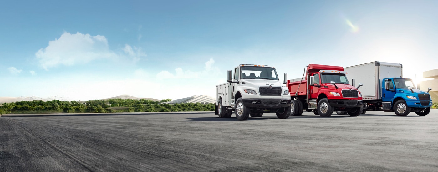 Row of new and pre-owned trucks priced to move