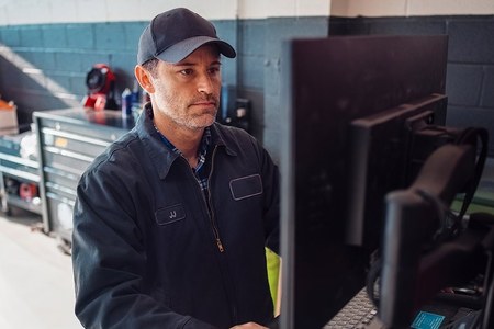 Parts technician ordering truck parts online at a workstation