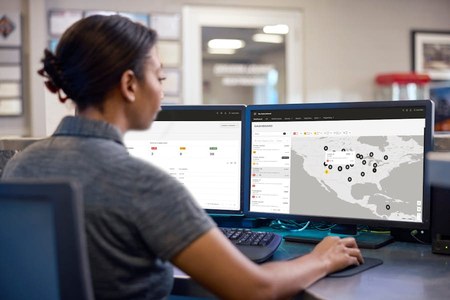 Fleet manager reviewing the My International dashboard on two monitors